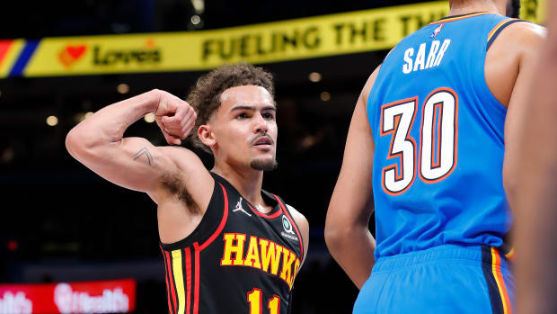 Mar 30, 2022; Oklahoma City, Oklahoma, USA; Atlanta Hawks guard Trae Young (11) gestures towards Oklahoma City Thunder center Olivier Sarr (30) after scoring a basket during the first half at Paycom Center.